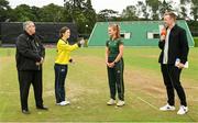 27 August 2023; Fox Lodge captain Kara Bates, second from left, and Merrion captain Niamh MacNulty, with match referee Phil Thompson, left, and presenter Shane Getkate during the coin toss before the Arachas Women's All-Ireland T20 Cup Final match between Merrion and Fox Lodge at Malahide Cricket Ground in Dublin. Photo by Seb Daly/Sportsfile