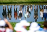 27 September 2023; Supporters are seen reflected in the water on the 16th hole during a practice round before the 2023 Ryder Cup at Marco Simone Golf and Country Club in Rome, Italy. Photo by Ramsey Cardy/Sportsfile