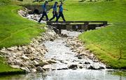 27 September 2023; Europe players, from left, Nicolai Højgaard, Rory McIlroy and Matt Fitzpatrick walk over a bridge onto the 16th green during a practice round before the 2023 Ryder Cup at Marco Simone Golf and Country Club in Rome, Italy. Photo by Brendan Moran/Sportsfile