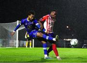 20 October 2023; Giles Phillips of Waterford in action against Success Edogun of Treaty United during the SSE Airtricity Men's First Division match between Waterford and Treaty United at RSC in Waterford. Photo by Michael P Ryan/Sportsfile