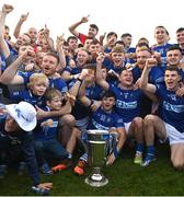 22 October 2023; Ardee St. Mary's players and supporters with the Joe Ward Cup after the Louth County Senior Club Football Championship final between Ardee St Mary's and Naomh Mairtin at Pairc Naomh Bríd in Dowdallshill, Louth. Photo by Stephen Marken/Sportsfile