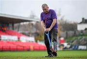 27 October 2023; Groundsman Kevin McCabe attempts to drain the pitch before the SSE Airtricity Men's Premier Division match between Cork City and Derry City at Turner's Cross in Cork. Photo by Eóin Noonan/Sportsfile