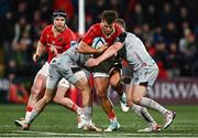 4 November 2023; Alex Nankivell of Munster is tackled by Jack Dixon, left, and Ashton Hewitt of Dragons during the United Rugby Championship match between Munster and Dragons at Musgrave Park in Cork. Photo by Eóin Noonan/Sportsfile