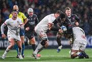 17 November 2023; Emmanuel Tshituka of Emirates Lions is tackled by Iain Henderson, left, and Alan O'Connor of Ulster during the United Rugby Championship match between Ulster and Emirates Lions at Kingspan Stadium in Belfast. Photo by Ramsey Cardy/Sportsfile