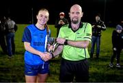 7 December 2023; Referee Eddie Cuthbert presents the cup to UCD captain Ciara Lawlor after the 3rd Level Ladies Football League Division 2 final match between UCD and Ulster University at Dundalk Institute of Technology in Dundalk, Louth. Photo by Ben McShane/Sportsfile