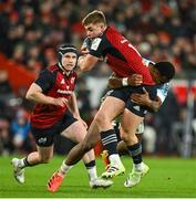 9 December 2023; Jack Crowley of Munster is tackled by Riko Buliruarua of Aviron Bayonnais during the Investec Champions Cup Pool 3 Round 1 match between Munster and Aviron Bayonnais at Thomond Park in Limerick. Photo by Brendan Moran/Sportsfile