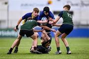 14 December 2023; Stephen Anderson of St Kevin’s Dunlavin is tackled by Archie Wakeford, left, and David Johnston of East Glendalough School during the Pat Rossiter Cup final match between East Glendalough School and St. Kevin’s Dunlavin at Energia Park in Dublin. Photo by Ben McShane/Sportsfile