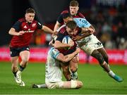 9 December 2023; Alex Nankivell of Munster is tackled by Rémi Bourdeau and Cheikh Tiberghien of Aviron Bayonnais during the Investec Champions Cup Pool 3 Round 1 match between Munster and Aviron Bayonnais at Thomond Park in Limerick. Photo by Brendan Moran/Sportsfile