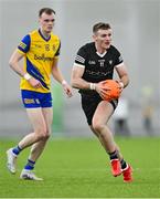 5 January 2024; Alan Reilly of Sligo gets away from Jack Duggan of Roscommon during the Connacht FBD League quarter-final match between Sligo and Roscommon at University of Galway Connacht GAA AirDome in Bekan, Mayo. Photo by Piaras Ó Mídheach/Sportsfile
