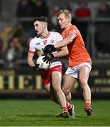 10 January 2024; James Donaghy of Tyrone in action against Cian McConville of Armagh during the Bank of Ireland Dr McKenna Cup Group A match between Armagh and Tyrone at BOX-IT Athletic Grounds in Armagh. Photo by Ben McShane/Sportsfile