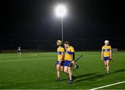10 January 2024; Clare players, from left, Gearóid Sheedy, John Conneally and Cian Galvin leave the pitch after their side's defeat in the Co-Op Superstores Munster Hurling League Group A match between Clare and Limerick at Clarecastle GAA astro pitch in Clare. Photo by Piaras Ó Mídheach/Sportsfile