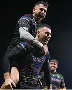 19 January 2024; Andrew Smith of Connacht, bottom, celebrates with teammate Tiernan O’Halloran after scoring their side's fourth try during the Investec Champions Cup Pool 1 Round 4 match between Connacht and Bristol Bears at the Dexcom Stadium in Galway. Photo by Seb Daly/Sportsfile