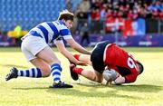 25 January 2024; Aiden McLoughlin of CUS scores his side's first try despite the tackle of Tommy Byrne of Good Counsel, New Ross, during the Bank of Ireland Leinster Rugby Schools Father Godfrey Cup semi-final match between Good Counsel, New Ross and CUS at Energia Park in Dublin. Photo by Ben McShane/Sportsfile