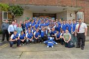 9 September 2013; Keenan Fitzpatrick, age 8, from Gorey, Co. Wexford, holds the Irish Press Cup with members of the Waterford squad, and hospital staff members, during a visit by the All-Ireland Minor Hurling Champions to Our Lady's Hospital for Sick Children, Crumlin. Picture credit: Barry Cregg / SPORTSFILE