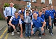 9 September 2013; Jack Mulhall, age 5, from Clonoulty, Cashel, Co. Tipperary, lifts the Irish Press Cup with members fo the Waterford squad on a visit by the All-Ireland Minor Hurling Champions to Our Lady's Hospital for Sick Children, Crumlin. Picture credit: Barry Cregg / SPORTSFILE