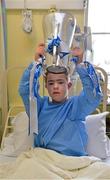 9 September 2013; Con Conlon, age 15, from O'Brien's Bridge, Co. Clare, lifts the Irish Press Cup on a visit by the All-Ireland Minor Hurling Champions to Our Lady's Hospital for Sick Children, Crumlin. Picture credit: Barry Cregg / SPORTSFILE