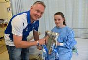 9 September 2013; Caoimhe Earls, age 13, from Abbeyleix, Co. Laois, holds the Irish Press Cup with Waterford manager Seán Power on a visit by the All-Ireland Minor Hurling Champions to Our Lady's Hospital for Sick Children, Crumlin. Picture credit: Barry Cregg / SPORTSFILE