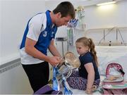 9 September 2013; Waterford captain Kevin Daly shows Morgan McCann, age 5, from Tallaght, Co. Dublin, the Irish Press Cup on a visit by the All-Ireland Minor Hurling Champions to Our Lady's Hospital for Sick Children, Crumlin. Picture credit: Barry Cregg / SPORTSFILE
