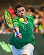 3 February 2024; Michael Agwi of Ireland in action against Dominic Thiem of Austria during their singles match on day one of the Davis Cup World Group I Play-off 1st Round match between Ireland and Austria at UL Sport Arena in Limerick. Photo by Brendan Moran/Sportsfile