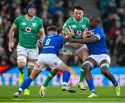 11 February 2024; Hugo Keenan of Ireland is tackled by Stephen Varney, left, and Alessandro Izekor of Italy during the Guinness Six Nations Rugby Championship match between Ireland and Italy at the Aviva Stadium in Dublin. Photo by Brendan Moran/Sportsfile