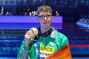 14 February 2024; Daniel Wiffen of Ireland celebrates with his gold medal after winning the Men's 800m freestyle final during day four of the World Aquatics Championships 2024 at the Aspire Dome in Doha, Qatar. Photo by Ian MacNicol/Sportsfile