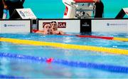 16 February 2024; Max McCusker of Ireland, left, after competing in the Men's 100m butterfly swim off heat against Matthew Sates of Republic of South Africa during day six of the World Aquatics Championships 2024 at the Aspire Dome in Doha, Qatar. Photo by Ian MacNicol/Sportsfile