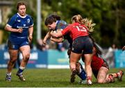 15 February 2024; Carla Cloney of Leinster is tackled by Lyndsay Clarke, 13, and Niamh O’Mahony of Munster during the U18 Girls Interprovincial semi-final match between Leinster and Munster at Terenure College RFC in Dublin. Photo by Shauna Clinton/Sportsfile