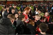 17 February 2024; Conor Glass of Derry sign autographs for supporters after the Allianz Football League Division 1 match between Derry and Monaghan at Celtic Park in Derry. Photo by Ramsey Cardy/Sportsfile