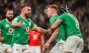 24 February 2024; Ciarán Frawley of Ireland, centre, celebrates with teammates Rónan Kelleher, left, and Caelan Doris after scoring their side's third try during the Guinness Six Nations Rugby Championship match between Ireland and Wales at Aviva Stadium in Dublin. Photo by Sam Barnes/Sportsfile