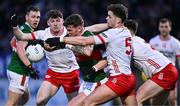 24 February 2024; Jordan Flynn of Mayo is tackled by Tyrone players, from left, Aidan Clarke, Michael McKernan and Conall Devlin during the Allianz Football League Division 1 match between Tyrone and Mayo at O'Neills Healy Park in Omagh, Tyrone. Photo by Ben McShane/Sportsfile