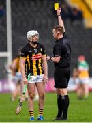 25 February 2024; Referee Thomas Gleeson shows a yellow card to Cian Kenny of Kilkenny during the Allianz Hurling League Division 1 Group A match between Kilkenny and Offaly at UPMC Nowlan Park in Kilkenny. Photo by Tom Beary/Sportsfile