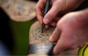 25 February 2024; Eoin Cody of Kilkenny signs his autograph on a hurl after the Allianz Hurling League Division 1 Group A match between Kilkenny and Offaly at UPMC Nowlan Park in Kilkenny. Photo by Tom Beary/Sportsfile