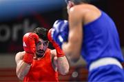 7 March 2024; Ali Habibinezhad of Iran, left, in action against Patris Mughalzai of Great Britain during their Men's 63.5kg Round of 32 bout during day five at the Paris 2024 Olympic Boxing Qualification Tournament at E-Work Arena in Busto Arsizio, Italy. Photo by Ben McShane/Sportsfile
