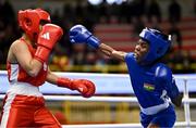 8 March 2024; Yi-Xuan Guo of Chinese Taipei, left, in action against Janet Acquah of Ghana during their Women's 50kg Round of 32 bout during day six at the Paris 2024 Olympic Boxing Qualification Tournament at E-Work Arena in Busto Arsizio, Italy. Photo by Ben McShane/Sportsfile