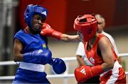 8 March 2024; Yi-Xuan Guo of Chinese Taipei, right, in action against Janet Acquah of Ghana during their Women's 50kg Round of 32 bout during day six at the Paris 2024 Olympic Boxing Qualification Tournament at E-Work Arena in Busto Arsizio, Italy. Photo by Ben McShane/Sportsfile