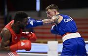 8 March 2024; Pedro Manuel Gomes of Angola, left, in action against Victor Tremblay of Canada during their Men's 57kg Round of 32 bout during day six at the Paris 2024 Olympic Boxing Qualification Tournament at E-Work Arena in Busto Arsizio, Italy. Photo by Ben McShane/Sportsfile