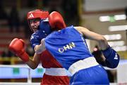 8 March 2024; Elise Glynn of Great Britain, left, in action against Zichun Xu of China during their Women's 57kg Round of 32 bout during day six at the Paris 2024 Olympic Boxing Qualification Tournament at E-Work Arena in Busto Arsizio, Italy. Photo by Ben McShane/Sportsfile