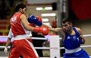 8 March 2024; Shakur Ovezov of Turkmenistan, left, in action against Daniyal Shahbakhsh of Iran during their Men's 57kg Round of 32 bout during day six at the Paris 2024 Olympic Boxing Qualification Tournament at E-Work Arena in Busto Arsizio, Italy. Photo by Ben McShane/Sportsfile