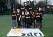 21 March 2024; A group of SARI's future Young Leaders, from left, Aaron, Larson, Kyle, Jager, Ola, Alberto and Max, with coaches Zinadine and Fayaaz, behind, celebrate International Day for the Elimination of Racial Discrimination at St Laurence O’Toole Recreation Centre in Dublin. Photo by Seb Daly/Sportsfile