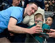 24 March 2024; Brian Fenton of Dublin takes a 'selfie' for a young supporter after the Allianz Football League Division 1 match between Dublin and Tyrone at Croke Park in Dublin. Photo by Ray McManus/Sportsfile