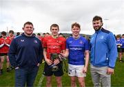 27 March 2024; North East captain Conor Goodwin and North Midlands captain Eanna Moynihan are presented with the cup by Ireland international and Leinster players Tadhg Furlong, left, and Caelan Doris after the BearingPoint Shane Horgan Cup Round 5 match between Midlands and North East at Carlow Institute of Technology in Carlow. Photo by Tyler Miller/Sportsfile