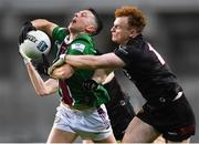 30 March 2024; Ronan O'Toole of Westmeath is tackled by Danny Magill of Down during the Allianz Football League Division 3 final match between Down and Westmeath at Croke Park in Dublin. Photo by Shauna Clinton/Sportsfile