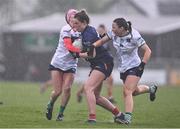 6 April 2024; Cliodhna Ni She of Carlow is tackled by Karen O'Leary, left, and Ellie Woulfe of Limerick during the Lidl LGFA National League Division 4 final match between Carlow and Limerick at St Brendan’s Park in Birr, Offaly. Photo by Ben McShane/Sportsfile