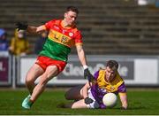 7 April 2024; Niall Hughes of Wexford in action against Mikey Bambrick of Carlow during the Leinster GAA Football Senior Championship Round 1 match between Wexford and Carlow at Chadwicks Wexford Park in Wexford. Photo by Tyler Miller/Sportsfile