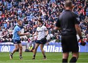 31 March 2024; Dublin goalkeeper Evan Comerford hands the ball to team-mate Paul Mannion, left, as he makes his way to take a penalty in the penalty shoot-out of the Allianz Football League Division 1 Final match between Dublin and Derry at Croke Park in Dublin. Photo by Piaras Ó Mídheach/Sportsfile