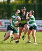 13 April 2024; Ellie White of Portdara is tackled by Rachel Clarke, left, and Muireann Cawley of Naas during the Leinster Rugby Girl's U18 semi-final match between Naas and Portdara at Naas RFC in Kildare. Photo by Tyler Miller/Sportsfile