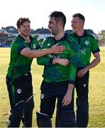 10 May 2024; Ireland players, from left, Barry McCarthy, Andrew Balbirnie and Harry Tector celebrate after their side's victory in match one of the Floki Men's T20 International Series between Ireland and Pakistan at Castle Avenue Cricket Ground in Dublin. Photo by Seb Daly/Sportsfile