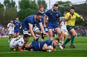 11 May 2024; Jordan Larmour of Leinster dives over to score his side's fifth try despite the tackle of Reuben Morgan-Williams of Ospreys during the United Rugby Championship match between Leinster and Ospreys at the RDS Arena in Dublin. Photo by Ben McShane/Sportsfile