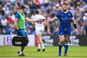11 May 2024; Andrew Porter of Leinster is handed his boot by Leinster head physiotherapist Garreth Farrell during the United Rugby Championship match between Leinster and Ospreys at the RDS Arena in Dublin. Photo by Ramsey Cardy/Sportsfile