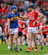 19 May 2024; John McGrath of Tipperary, left, and Robert Downey of Cork after the Munster GAA Hurling Senior Championship Round 4 match between Tipperary and Cork at FBD Semple Stadium in Thurles, Tipperary. Photo by Brendan Moran/Sportsfile